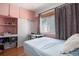 Bedroom featuring built-in storage, a dedicated workspace, and a comfortable bed at 1910 S King St, Denver, CO 80219