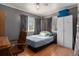 Modest bedroom with laminate floor, window views, and closet storage at 1910 S King St, Denver, CO 80219