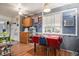 Cozy dining area with hardwood floors, a ceiling fan, and a window overlooking the backyard at 1910 S King St, Denver, CO 80219