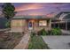 Charming home with a well-maintained front yard, walkway, and covered porch with a metal awning and decorative posts at 1910 S King St, Denver, CO 80219
