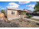 Charming home with a well-maintained front yard, walkway, and covered porch with a metal awning and decorative posts at 1910 S King St, Denver, CO 80219