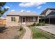 Charming home with a well-maintained front yard, walkway, and covered porch with a metal awning and decorative posts at 1910 S King St, Denver, CO 80219