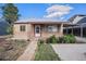 Charming home with a well-maintained front yard, walkway, and covered porch with a metal awning and decorative posts at 1910 S King St, Denver, CO 80219