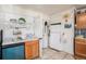 A look at the kitchen with white countertops, vintage appliances, and ample storage at 1910 S King St, Denver, CO 80219