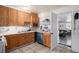 This kitchen features wood cabinets, white countertops, and tiled floors at 1910 S King St, Denver, CO 80219