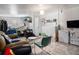 The living room features tile flooring, a comfortable sofa, and a washer and dryer at 1910 S King St, Denver, CO 80219