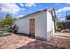 This shed features stucco siding, a wood door, and a basketball hoop at 1910 S King St, Denver, CO 80219