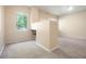 A bedroom area with plush carpet, neutral paint and a view of the backyard trees from a large window at 8467 Canyon Rim Cir # 302, Englewood, CO 80112