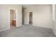Spacious bedroom features neutral paint, plush carpet, and doorways to closet and bathroom at 8467 Canyon Rim Cir # 302, Englewood, CO 80112