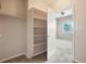 Walk-in closet features adjustable shelving and a view of a bedroom with windows at 8467 Canyon Rim Cir # 302, Englewood, CO 80112