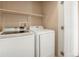 Laundry room featuring a washer and dryer with white cabinets at 8467 Canyon Rim Cir # 302, Englewood, CO 80112