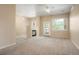 Cozy living room with a fireplace, carpeted floors, and a sliding door that leads to a balcony at 8467 Canyon Rim Cir # 302, Englewood, CO 80112