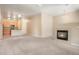 A carpeted living room features a fireplace and connects to an adjacent kitchen, creating a seamless living space at 8467 Canyon Rim Cir # 302, Englewood, CO 80112