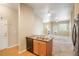 Open-concept living area featuring a fireplace, plush carpeting, and an abundance of natural light at 8467 Canyon Rim Cir # 302, Englewood, CO 80112