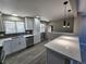 Open kitchen boasts white cabinets, quartz countertops, and an island at 8954 N Carr Cir, Broomfield, CO 80021