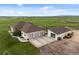 Aerial view of a ranch home with a three-car garage and an outbuilding at 15125 Spring Valley Rd, Larkspur, CO 80118