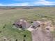 Expansive property featuring lush green pastures, mountain views, a detached garage, and a greenhouse at 15125 Spring Valley Rd, Larkspur, CO 80118