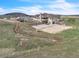 A large backyard has a patio, plus a sandbox, offering space for outdoor activities and entertainment at 15125 Spring Valley Rd, Larkspur, CO 80118