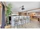 Bar area with high seating, a view into the theater room, and a pool table in the adjacent space at 15125 Spring Valley Rd, Larkspur, CO 80118