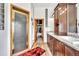 Bathroom with glass shower, marble counter tops and plentiful cabinetry at 15125 Spring Valley Rd, Larkspur, CO 80118