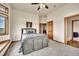 A neutral bedroom features a wood-frame bed, and plush carpeting to create a relaxing atmosphere at 15125 Spring Valley Rd, Larkspur, CO 80118