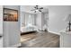Bright bedroom features a ceiling fan, hardwood floors, and vanity with white walls at 15125 Spring Valley Rd, Larkspur, CO 80118