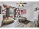 Unique bedroom with a bed and fun colors, plus a ceiling fan to help cool during the warmer months at 15125 Spring Valley Rd, Larkspur, CO 80118