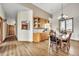 Dining area featuring a wet bar, wood floors, and a stylish chandelier at 15125 Spring Valley Rd, Larkspur, CO 80118
