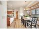 Open floor plan to the dining area with wood floors, a large window, and modern lighting at 15125 Spring Valley Rd, Larkspur, CO 80118