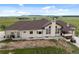 Single-story home featuring a manicured lawn, a stone chimney, and neutral-toned paint at 15125 Spring Valley Rd, Larkspur, CO 80118