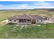 Expansive ranch home with a covered patio and an additional building on acreage at 15125 Spring Valley Rd, Larkspur, CO 80118