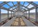 The greenhouse structure is made of metal and glass, and set for a variety of gardening at 15125 Spring Valley Rd, Larkspur, CO 80118