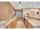 Kitchenette with long granite countertop, cabinets, small window and open access to the main living area at 15125 Spring Valley Rd, Larkspur, CO 80118