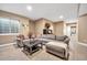 A comfortable living room provides ample seating with a cozy couch, decorative pieces and neutral-toned walls at 15125 Spring Valley Rd, Larkspur, CO 80118