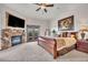 Relaxing main bedroom featuring a stone fireplace and balcony access at 15125 Spring Valley Rd, Larkspur, CO 80118