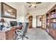 Bright office space with wooden desk, chair, shelving and grandfather clock at 15125 Spring Valley Rd, Larkspur, CO 80118