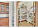 Well-organized pantry with floor to ceiling shelves and plentiful storage space at 15125 Spring Valley Rd, Larkspur, CO 80118