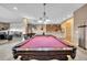 Pool table area with access to bar, and theater room for entertainment, and adjacent shuffle board area at 15125 Spring Valley Rd, Larkspur, CO 80118
