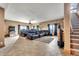Spacious theater room with tiered seating, a large screen, and a staircase nearby at 15125 Spring Valley Rd, Larkspur, CO 80118