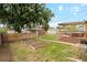 Landscaped backyard featuring raised garden beds, wood fence, and a multi-level deck with a pergola at 2929 N Columbine St, Denver, CO 80205