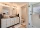 Bright bathroom featuring double sinks with granite countertops and a tiled shower at 8985 Lander St, Westminster, CO 80031