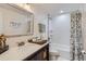 Bright bathroom featuring a granite vanity with an enclosed bathtub and shower at 8985 Lander St, Westminster, CO 80031