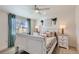 Charming bedroom featuring a white bed frame, wooden nightstands and bright window at 8985 Lander St, Westminster, CO 80031
