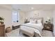 Comfortable bedroom with neutral carpet, bench seating beneath the window, and wall art at 8985 Lander St, Westminster, CO 80031