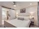 Bright bedroom featuring a white bed frame with ensuite bathroom access through a sliding barn door at 8985 Lander St, Westminster, CO 80031