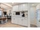 Coffee bar with white cabinets and countertop, adding a touch of luxury to the dining area at 8985 Lander St, Westminster, CO 80031