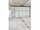 Spacious garage with large door and a blue pedestrian door in the back at 8985 Lander St, Westminster, CO 80031