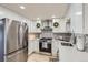 Well-lit kitchen with stainless steel refrigerator and modern stove, creating a functional and stylish space at 8985 Lander St, Westminster, CO 80031