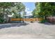 View of the house and backyard with parking area with steps to the fenced in backyard at 4818 Bryant St, Denver, CO 80221