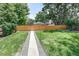 An eye-level backyard with a stone path and lush green grass at 4818 Bryant St, Denver, CO 80221